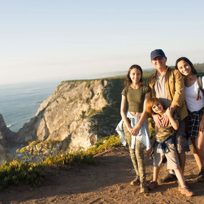 happy father hiking with children in mountains