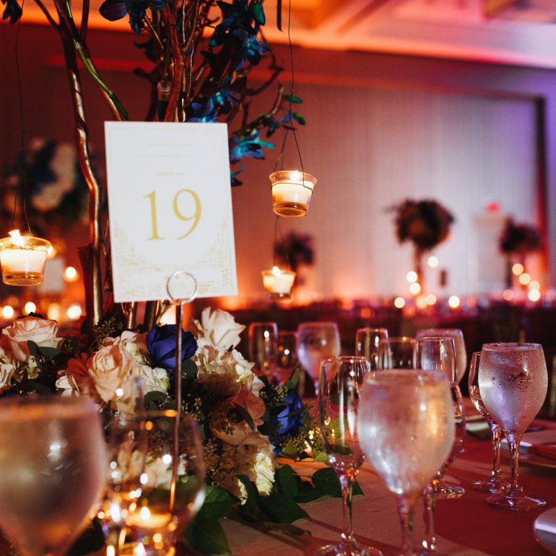 wine glasses on the served table with lightening candles and tab