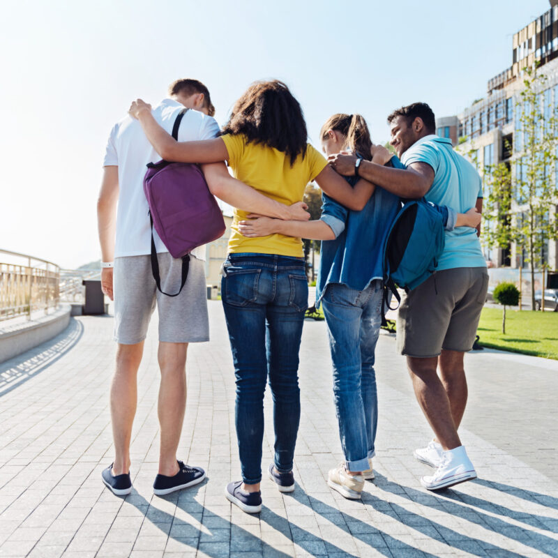 group of friendly students walking through the pass